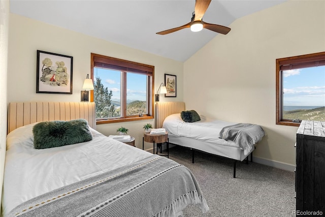 carpeted bedroom featuring lofted ceiling, radiator, and ceiling fan