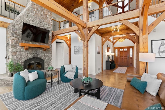 13326 Kuehster Rd, Littleton, CO 80127 - living room with wood finished floors, high vaulted ceiling, a fireplace, beamed ceiling, and wooden ceiling