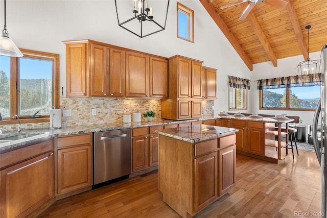 13326 Kuehster Rd, Littleton, CO 80127 - kitchen featuring stainless steel dishwasher, brown cabinetry, and a sink