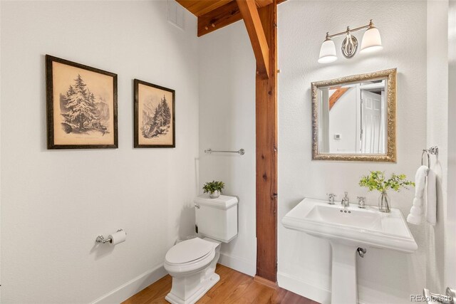 13326 Kuehster Rd, Littleton, CO 80127 - half bath with toilet, wood finished floors, beam ceiling, and baseboards