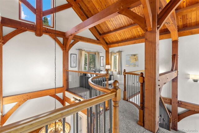 13326 Kuehster Rd, Littleton, CO 80127 - hall with an upstairs landing, carpet, wood ceiling with exposed beams, and high vaulted ceiling