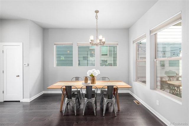 dining room featuring a chandelier and dark hardwood / wood-style floors