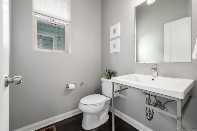 bathroom featuring toilet and sink