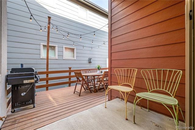 wooden terrace with a grill