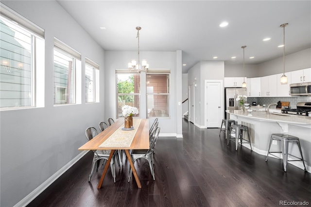 dining space with dark hardwood / wood-style flooring and a chandelier