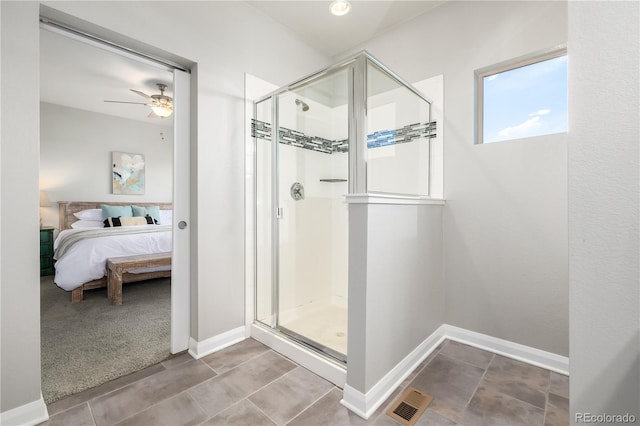 bathroom featuring ceiling fan and a shower with shower door