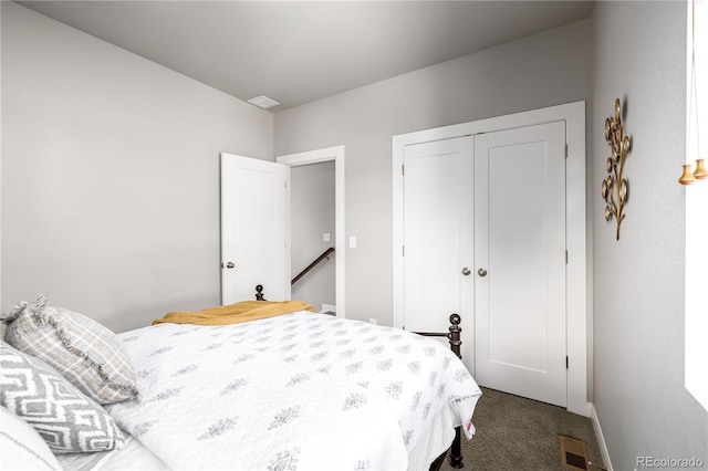 bedroom with a closet and dark colored carpet