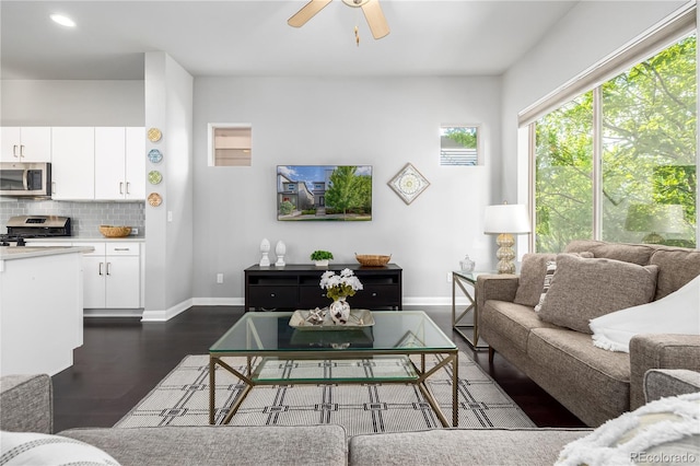 living room featuring dark hardwood / wood-style floors and ceiling fan