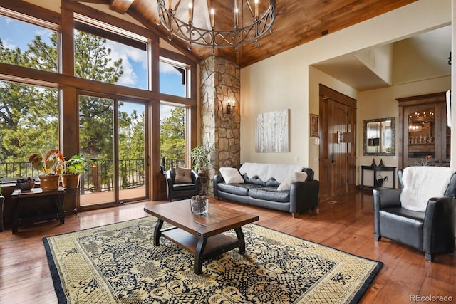 living room featuring dark hardwood / wood-style flooring, high vaulted ceiling, a chandelier, and wooden ceiling