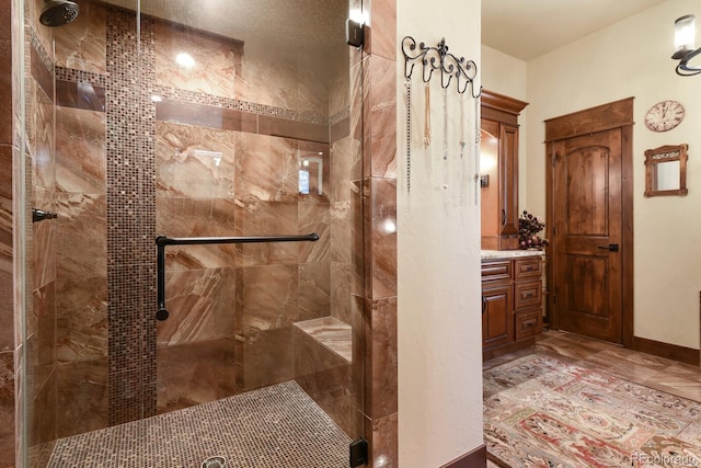 bathroom with vanity and a shower with shower door