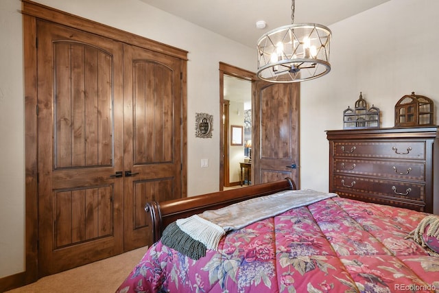 carpeted bedroom featuring a notable chandelier