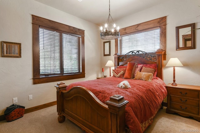 bedroom with an inviting chandelier and light carpet