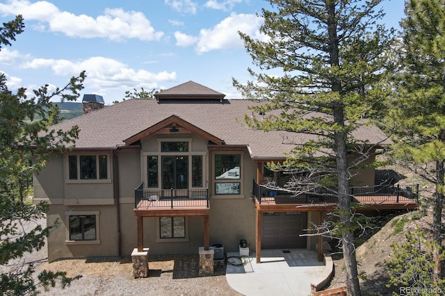 exterior space with a balcony and a garage