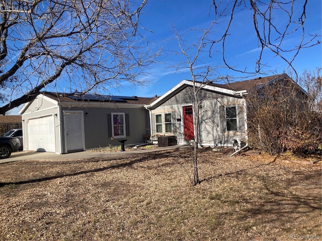 view of front of house featuring solar panels and a garage