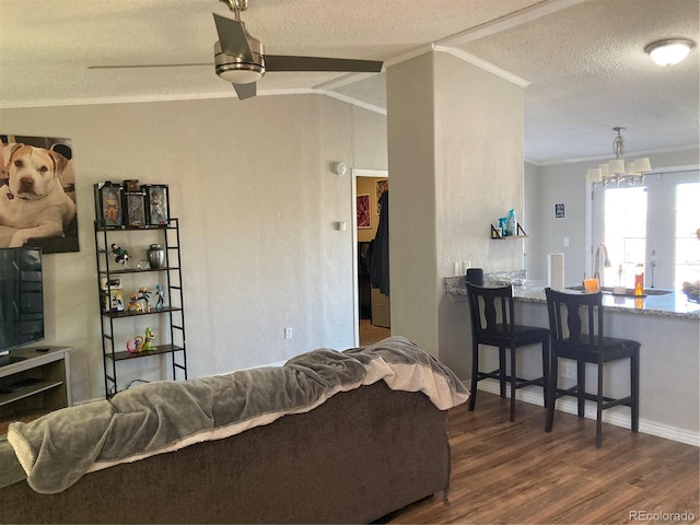1103 Stage Dr, Fort Lupton, CO 80621 - living room featuring crown molding, a textured ceiling, wood finished floors, and a chandelier