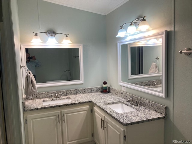 1103 Stage Dr, Fort Lupton, CO 80621 - bathroom featuring double vanity and crown molding