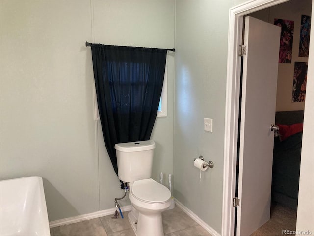 bathroom with tile patterned floors and toilet