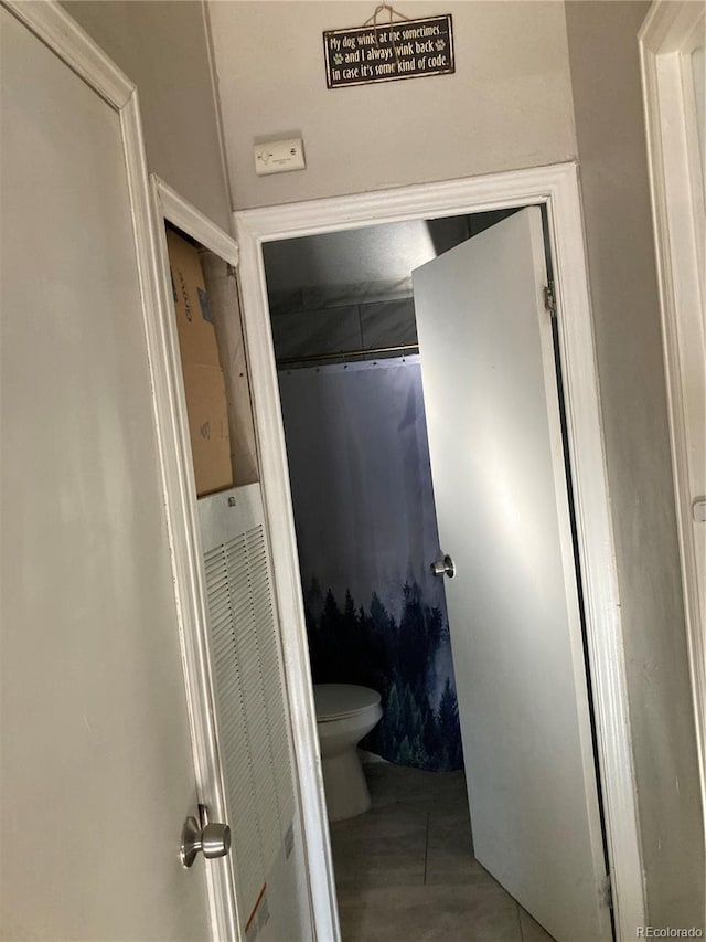 bathroom featuring tile patterned floors and toilet