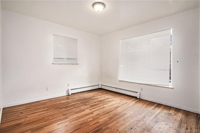 3306 S Uinta Ct, Denver, CO 80231 - unfurnished room featuring a baseboard heating unit and wood finished floors