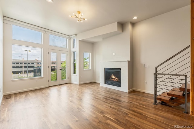 2680 Blake St Unit 4, Denver, CO 80205 - unfurnished living room with stairs, a glass covered fireplace, wood finished floors, and recessed lighting