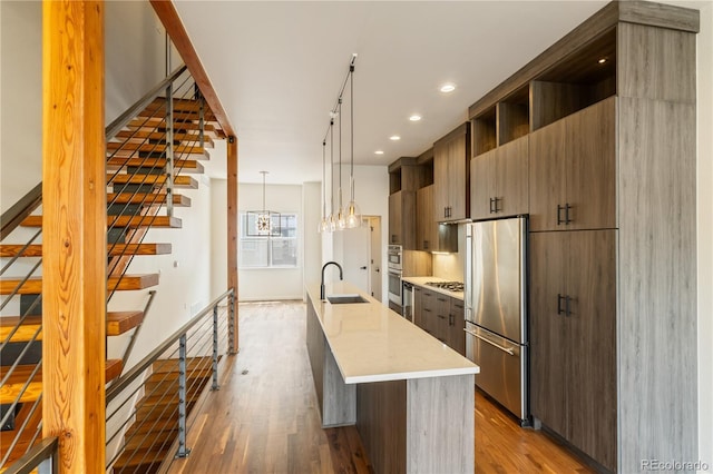 2680 Blake St Unit 4, Denver, CO 80205 - kitchen with stainless steel appliances, modern cabinets, wood finished floors, light countertops, and recessed lighting