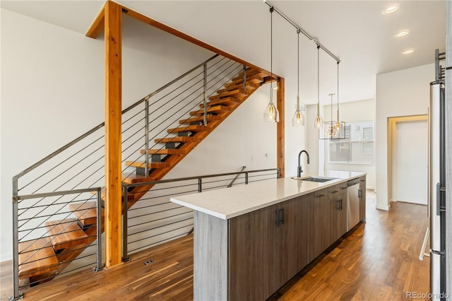 2680 Blake St Unit 4, Denver, CO 80205 - kitchen featuring stainless steel appliances, dark wood-style flooring, light countertops, a center island with sink, and recessed lighting