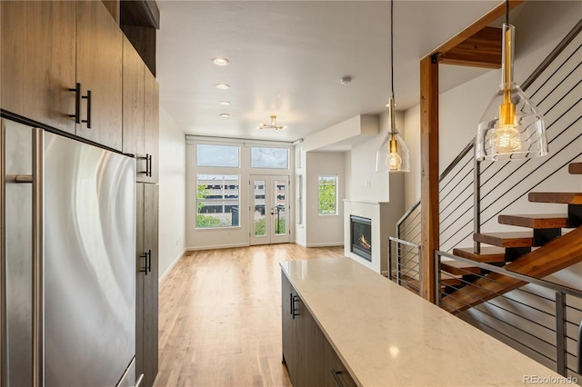 2680 Blake St Unit 4, Denver, CO 80205 - entryway featuring light wood finished floors, stairway, recessed lighting, and a glass covered fireplace