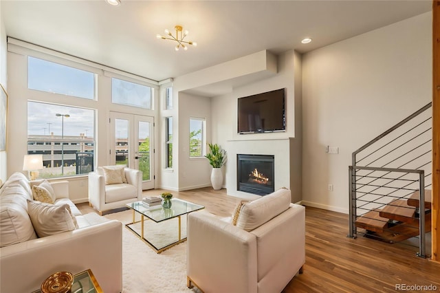 2680 Blake St Unit 4, Denver, CO 80205 - living room with stairway, wood finished floors, a glass covered fireplace, and recessed lighting