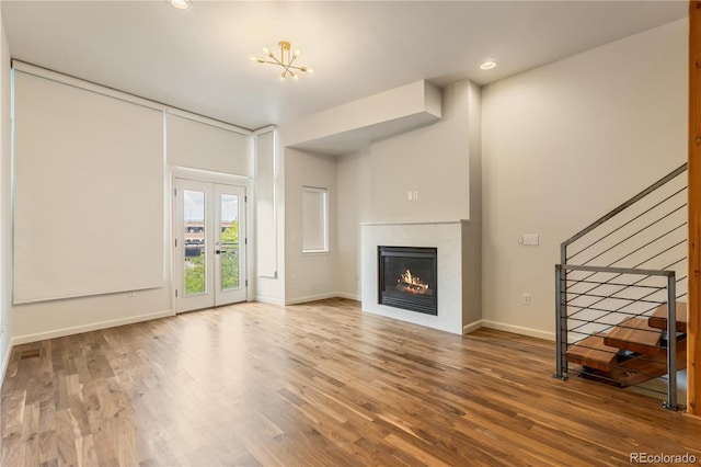 2680 Blake St Unit 4, Denver, CO 80205 - unfurnished living room featuring stairway, a glass covered fireplace, wood finished floors, and recessed lighting