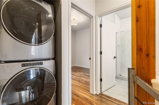 2680 Blake St Unit 4, Denver, CO 80205 - washroom featuring stacked washer and clothes dryer and light wood-style floors