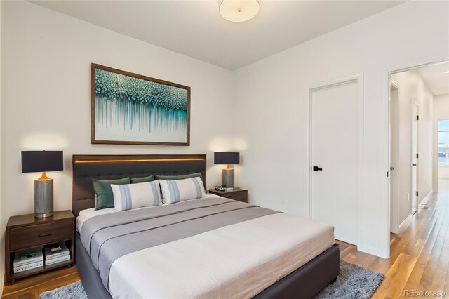 2680 Blake St Unit 4, Denver, CO 80205 - bedroom with light wood finished floors and baseboards