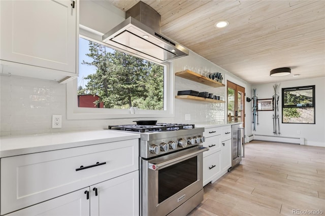 8940 S Brandenburger Dr, Morrison, CO 80465 - kitchen with high end stainless steel range oven, a baseboard heating unit, wooden ceiling, wall chimney exhaust hood, and white cabinetry