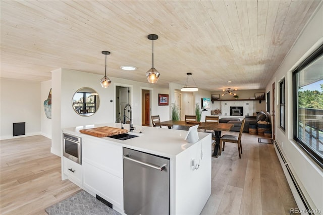8940 S Brandenburger Dr, Morrison, CO 80465 - kitchen featuring stainless steel dishwasher, a baseboard heating unit, open floor plan, wood ceiling, and white cabinetry