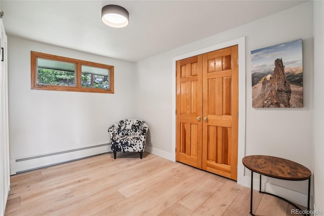 8940 S Brandenburger Dr, Morrison, CO 80465 - living area with a baseboard radiator and light wood-style flooring