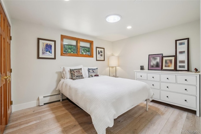 8940 S Brandenburger Dr, Morrison, CO 80465 - bedroom with a baseboard radiator, light wood-style floors, and recessed lighting