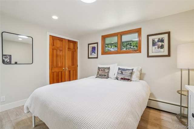 8940 S Brandenburger Dr, Morrison, CO 80465 - bedroom with a baseboard heating unit, wood finished floors, and recessed lighting