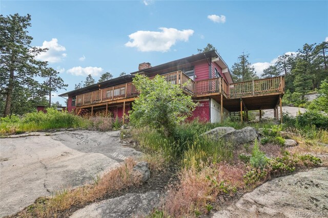 8940 S Brandenburger Dr, Morrison, CO 80465 - back of property with a deck and a chimney