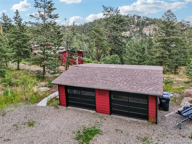 8940 S Brandenburger Dr, Morrison, CO 80465 - detached garage with a view of trees