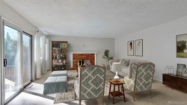 living room featuring a textured ceiling, a brick fireplace, and light colored carpet