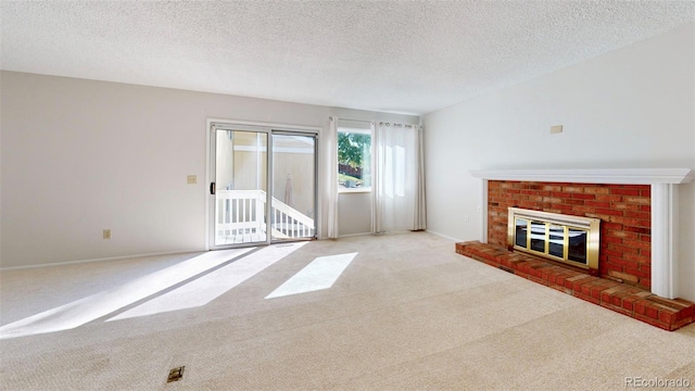 unfurnished living room featuring a brick fireplace, a textured ceiling, and light carpet