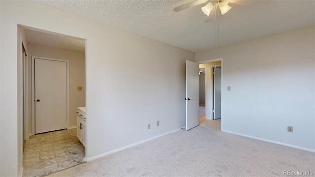 empty room with light carpet, a textured ceiling, and ceiling fan