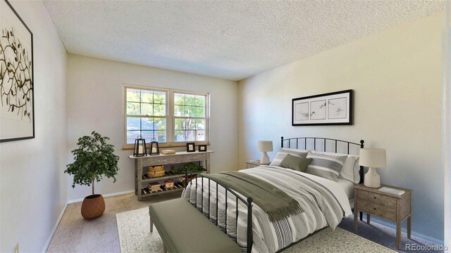 bedroom featuring carpet flooring and a textured ceiling