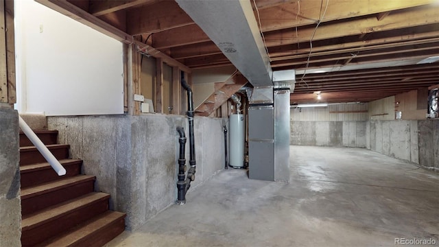 basement featuring heating unit and water heater