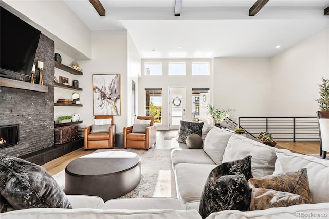 6589 Canyonpoint Rd, Castle Pines, CO 80108 - living room with recessed lighting, wood finished floors, beam ceiling, and a stone fireplace