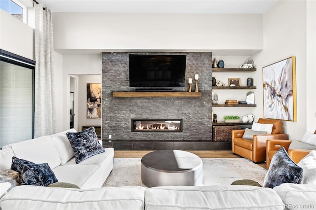 6589 Canyonpoint Rd, Castle Pines, CO 80108 - living area featuring a large fireplace and wood finished floors