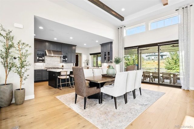 6589 Canyonpoint Rd, Castle Pines, CO 80108 - dining area with recessed lighting, a healthy amount of sunlight, light wood finished floors, and a towering ceiling