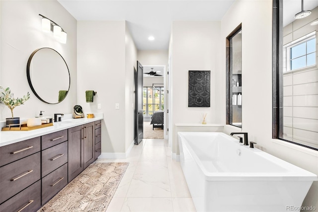 6589 Canyonpoint Rd, Castle Pines, CO 80108 - full bath featuring a freestanding tub, a wealth of natural light, marble finish floor, and vanity