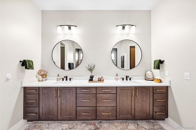 6589 Canyonpoint Rd, Castle Pines, CO 80108 - bathroom with baseboards, a sink, and double vanity