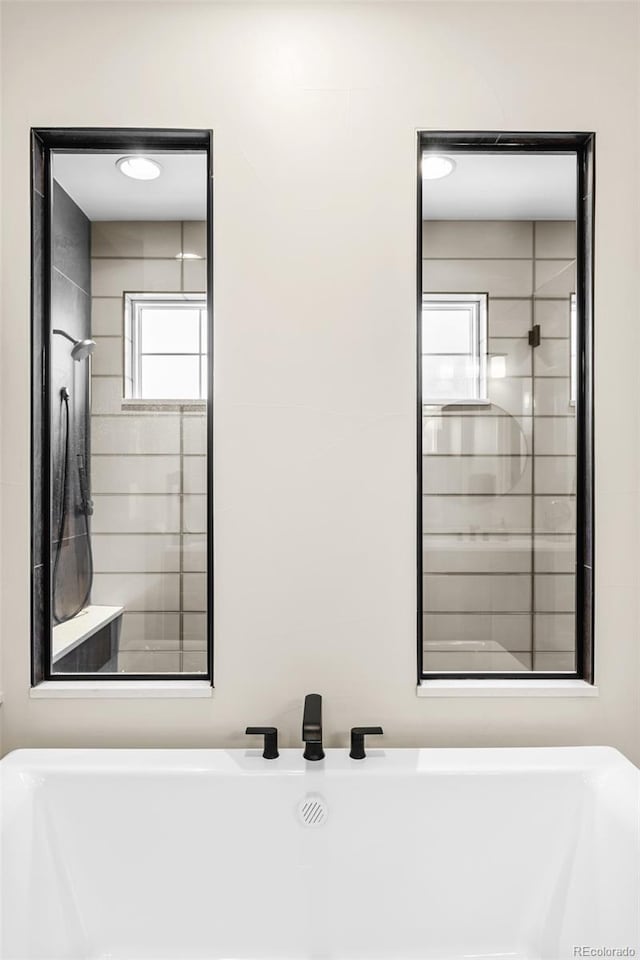 6589 Canyonpoint Rd, Castle Pines, CO 80108 - bathroom featuring a soaking tub and tiled shower