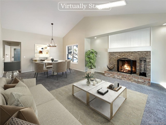 carpeted living room featuring a brick fireplace and lofted ceiling